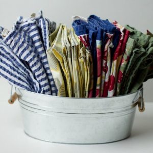 Colorful cloth napkins folded and organized in a mini galvanized tub #functionaldiningroom