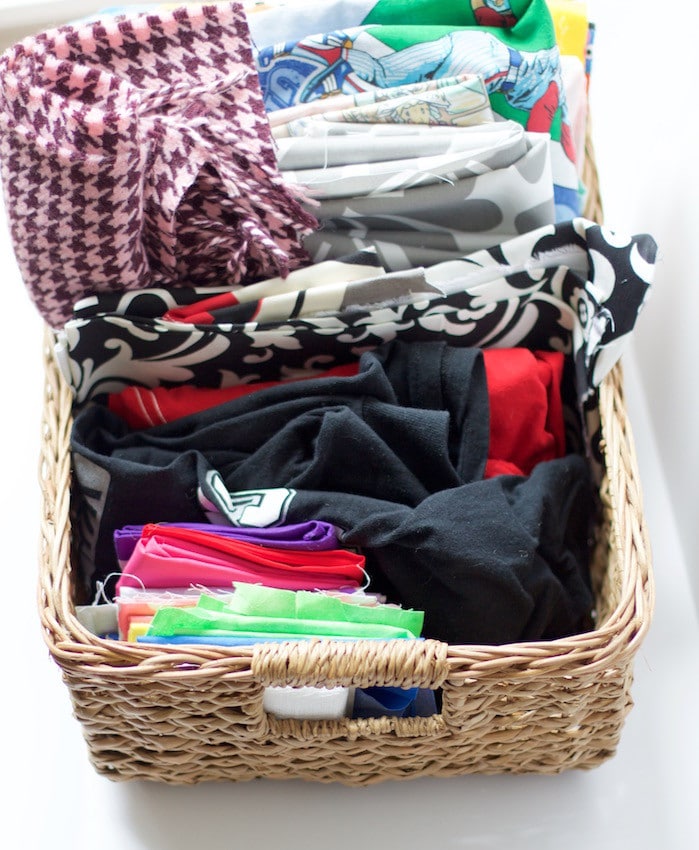 Basket full of colorful fabrics to show how to organize craft supplies. #fabric #organized