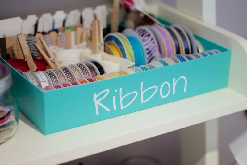 Box top with label saying "ribbon", with ribbon spools inside organized by color #organized #ribbon