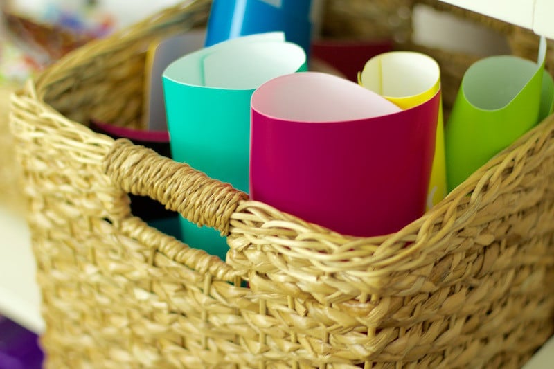 Colored sheets of vinyl in a wicker basket #craftstorage