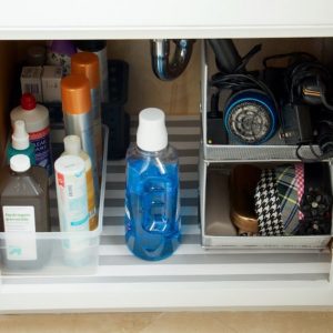 Under the sink storage with lined shelves and plastic and metal bins #bathroomorganization
