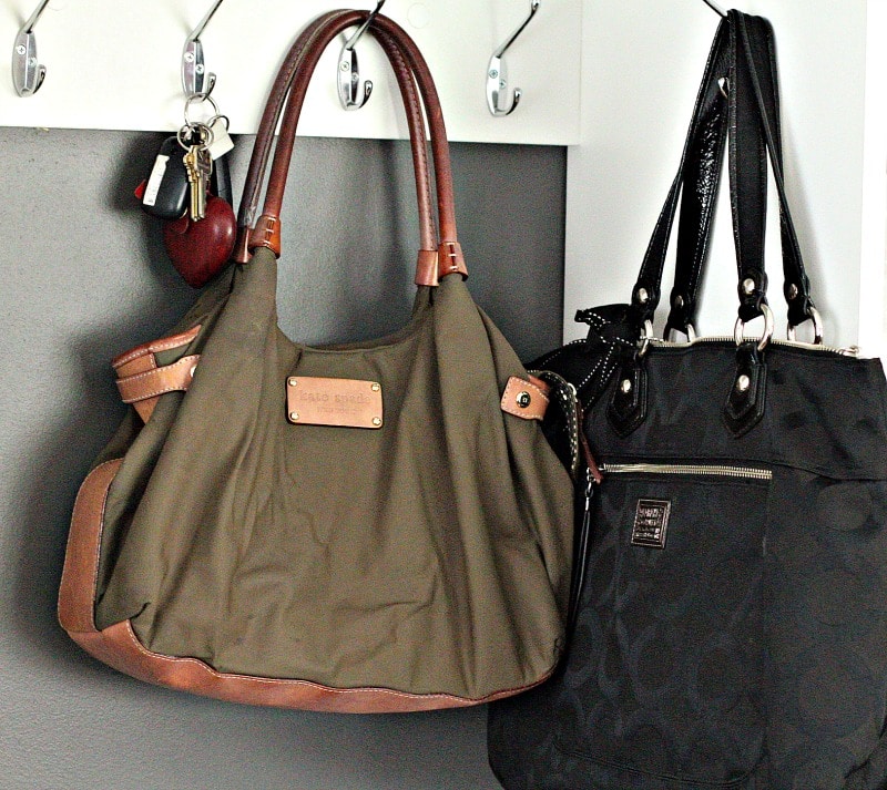 Two purses and a set of keys hanging on hooks #organizing