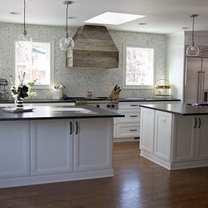 Updated kitchen with finished hood, white cabinets, and black countertops #kitchen #farmhouse