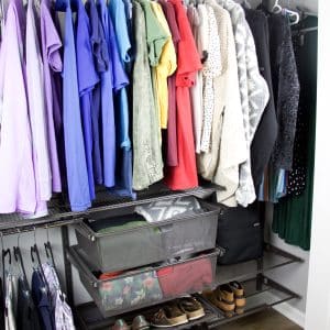 closet with rainbow color coded clothing hanging