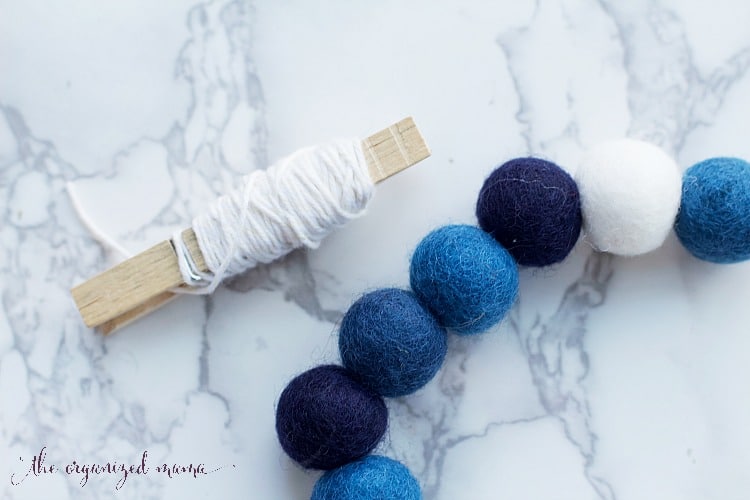 Using dollar store felt balls, I created Hanukkah decorations for the mantel and around the home. Add some festive decor to your home with ease! #hanukkah #diy #decor