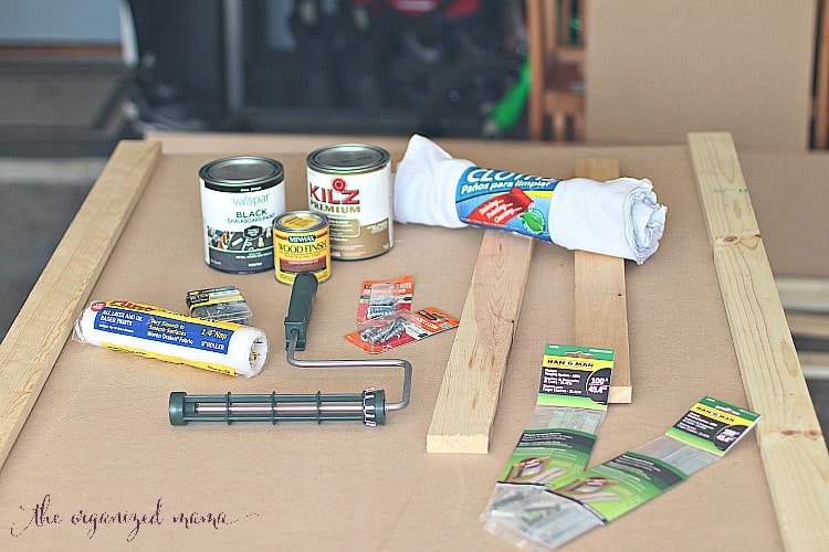 all materials needed to create simple extra large chalkboard including MDF board, stain, chalkboard paint, and finishing nails