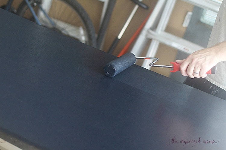 Using chalkboard paint and a roller brush to paint simple extra large chalkboard