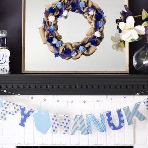 Learn how to create a happy Hanukkah rustic wood sign using Sharpie brush pens, Elmer's Glitter Glue, and a wooden sign from Michaels!
