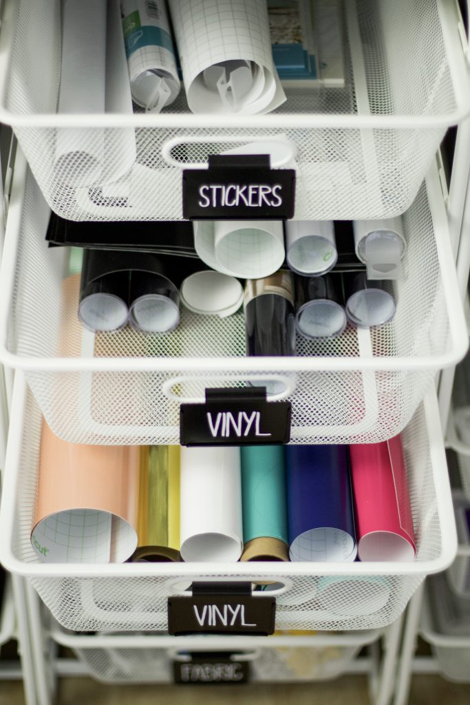 Vinyl and stickers are beautifully organized into drawers with black labels and white lettering to help keep everything organized for craft supplies within elfa drawers. #craftorganization