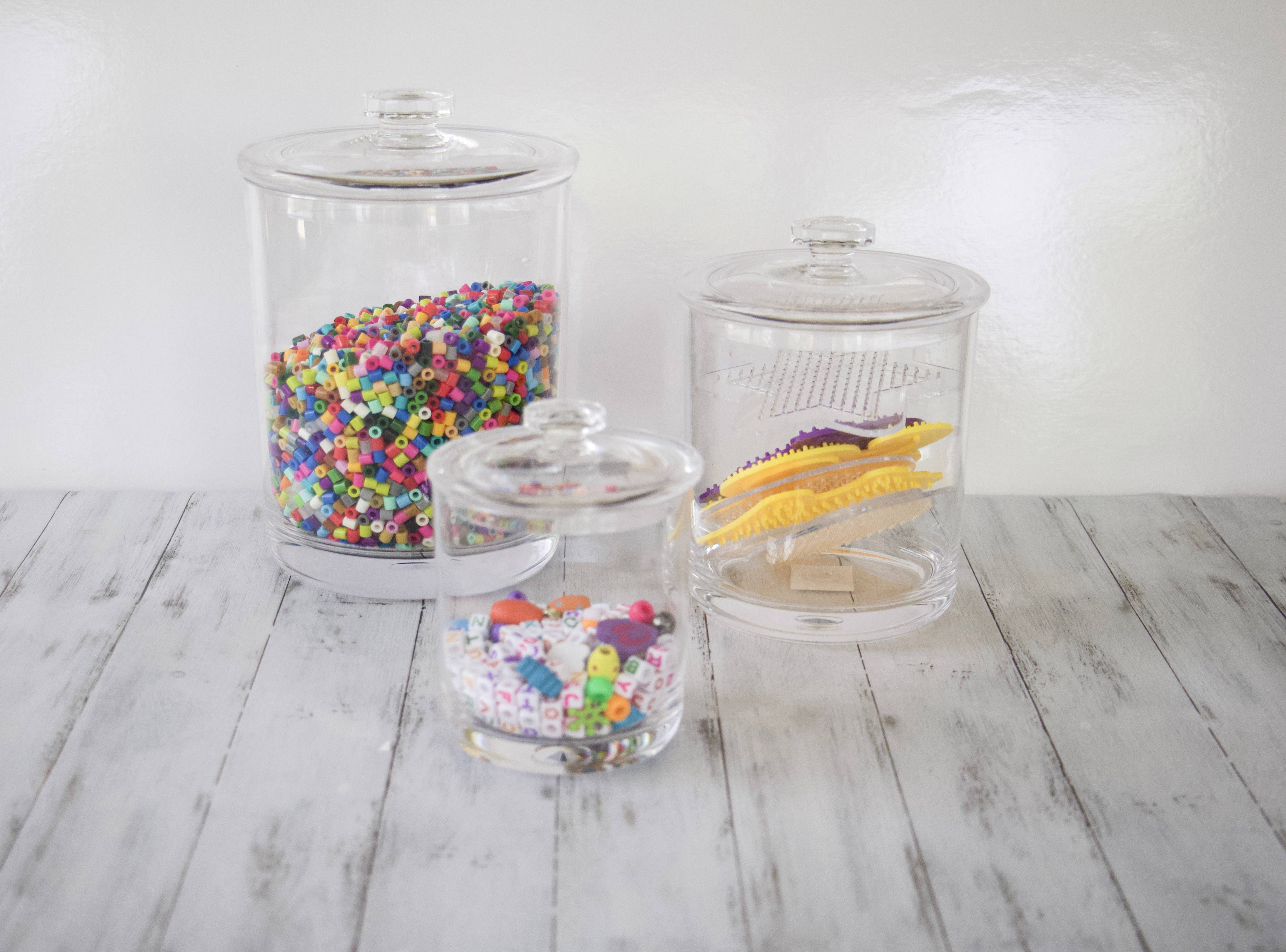 3 different size acylic canisters holding beads to demonstrate how to store pearler beads and other small bead supplies for kids #artorganization #shoplikeaprofessional