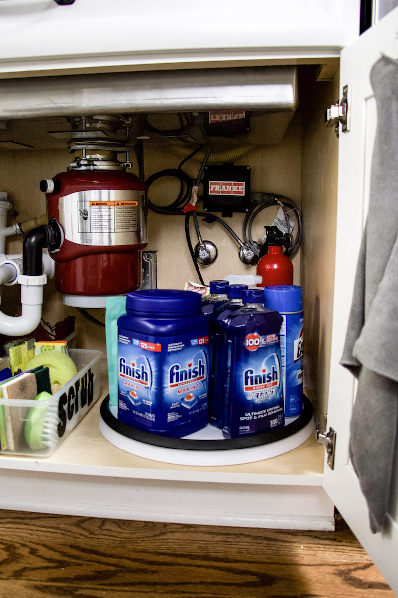 under kitchen sink turntable with cleaning supplies and dishwasher detergent #kitchenorganization