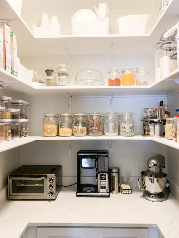 Tidy pantry shelves with clear, labelled containers 