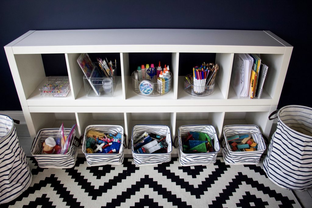 Organized shelves in playroom to represent skills to help kids get organized #organizedkids