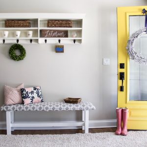 Entryway with yellow door and pink boots #organizedkids
