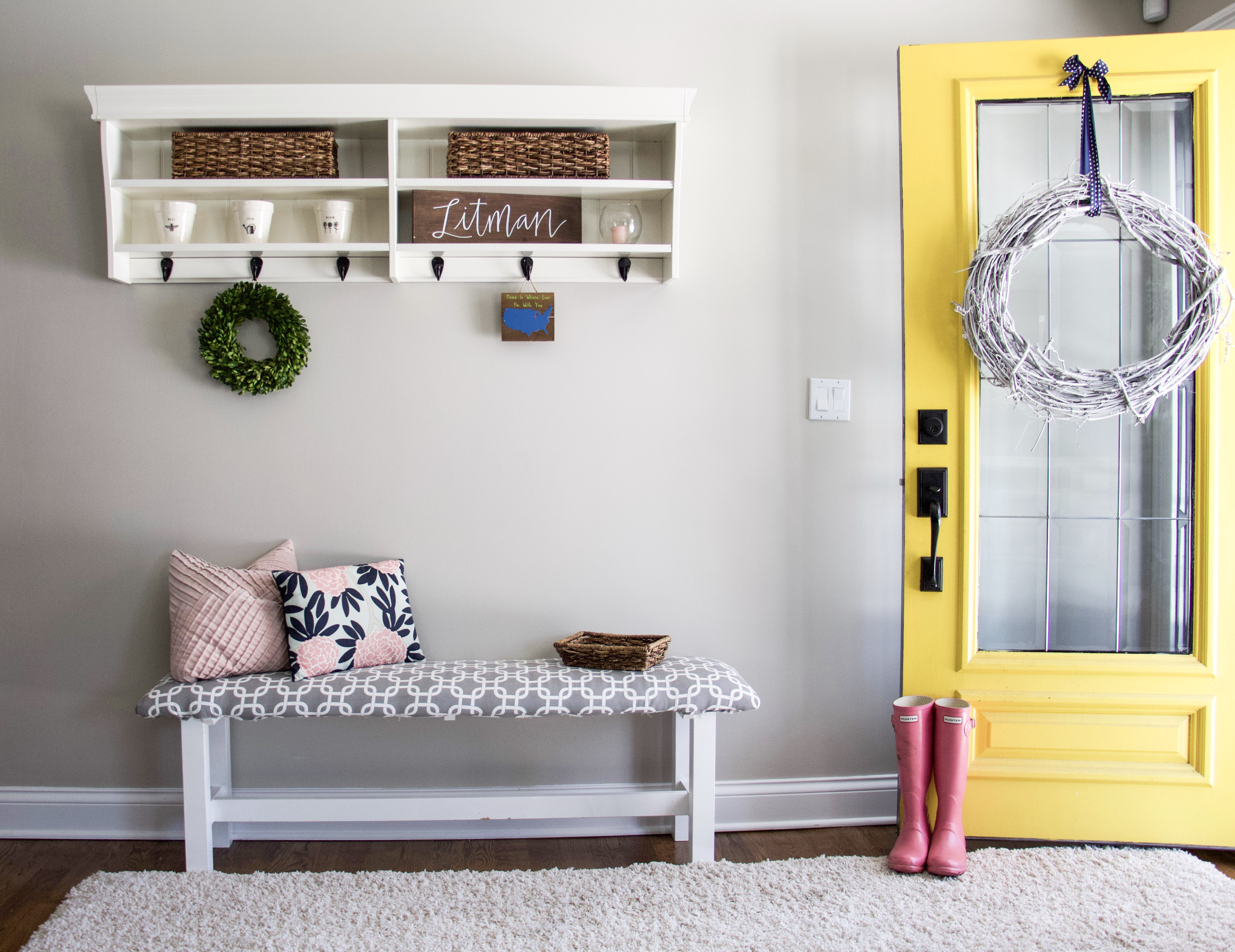 Entryway with yellow door and pink boots #organizedkids