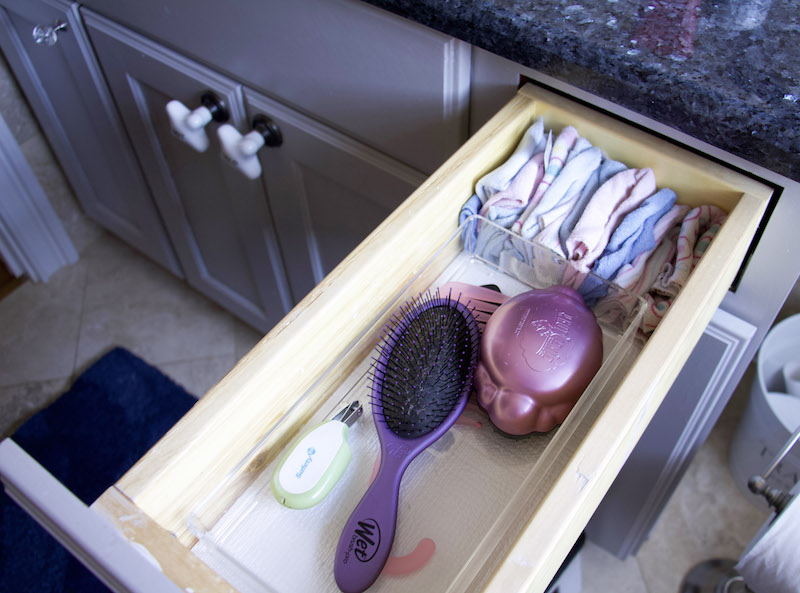 kids bathroom vanity drawer organizer with hairbrushes and wash rags