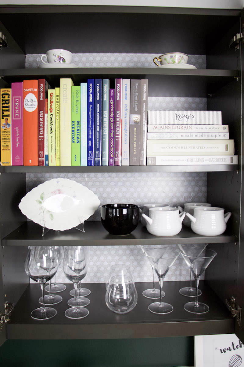 cabinet with cookbooks and bowls with basket weave easy liner on the back of cabinet