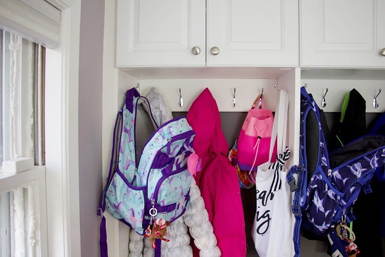 Daughter's jackets and backpack in mudroom section #organization 
