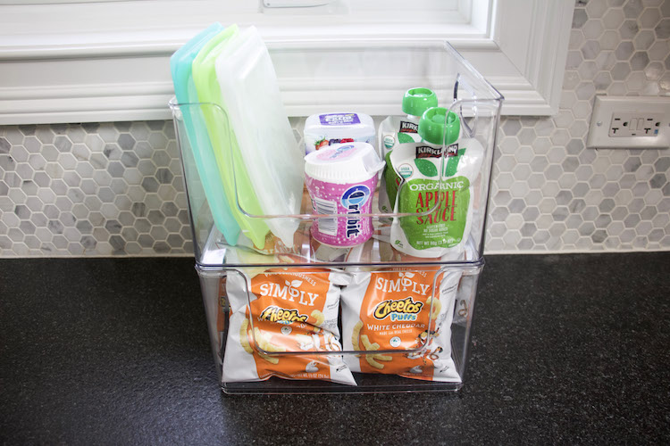 snack station on countertop organized using idesign stackable pantry bins