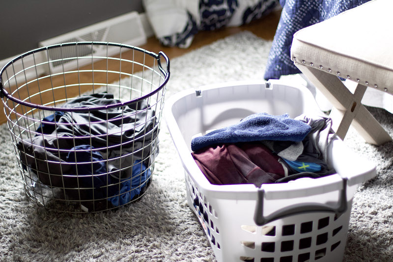 laundry in bedroom with one basket for dirty clothing and the other for clean to demonstrate laundry hacks