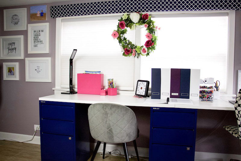 homeschool desk with materials and wreath over window