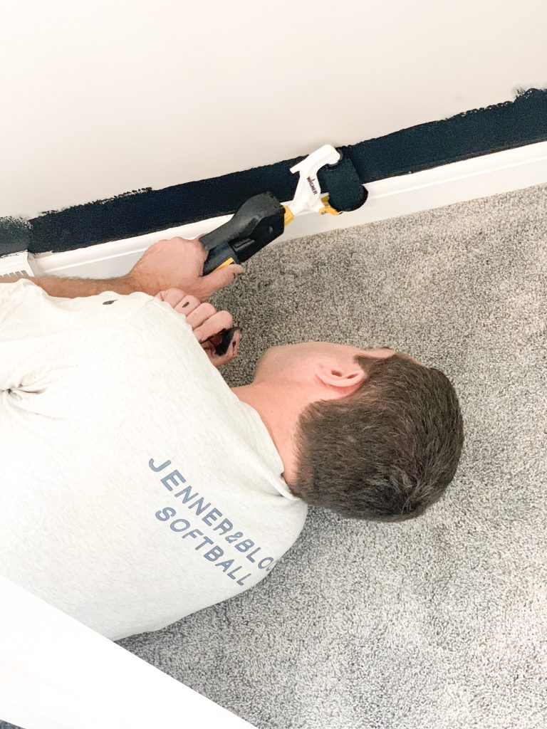 husband painting wall with Wagner Smart Edge Roller