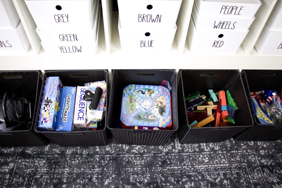 bins with toys stored in IKEA kallax shelving unit turned on its side