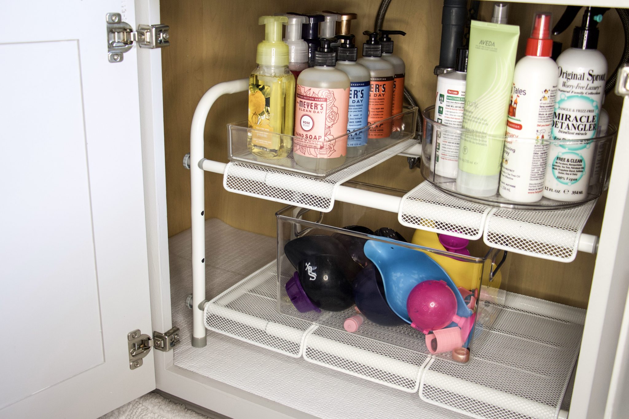 bathroom under sink storage with organizers and turntables