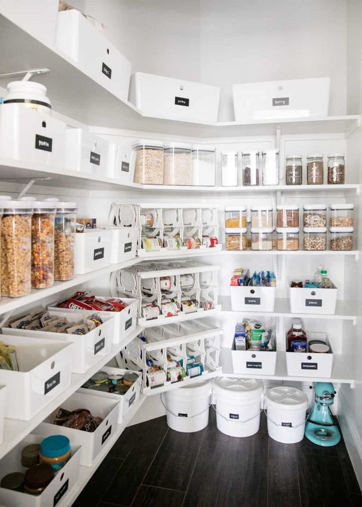 walk in pantry organized with white bins