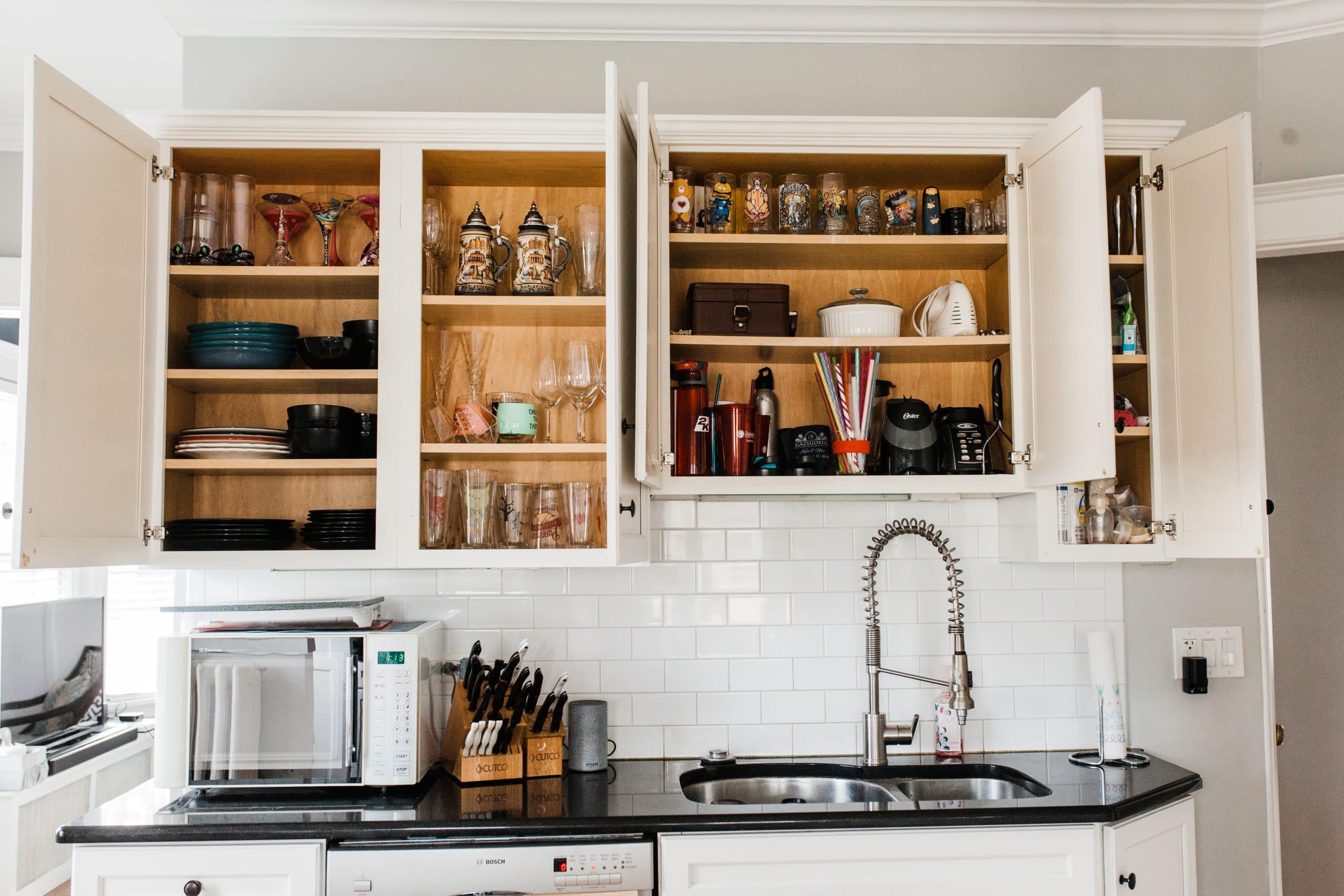 picture of kitchen cabinets with doors open and shelves beautifully organized