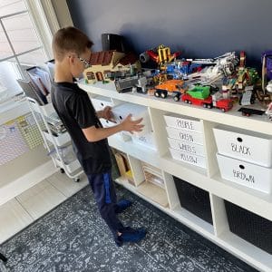 The Organized Kids showing lego storage system by putting away lego bricks