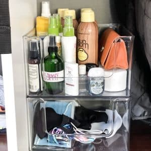 mask storage in stackable bin with masks on bottom and sunscreen on top