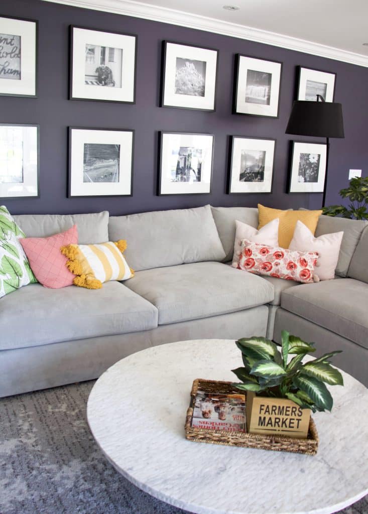 couch with gallery wall and colorful pillows