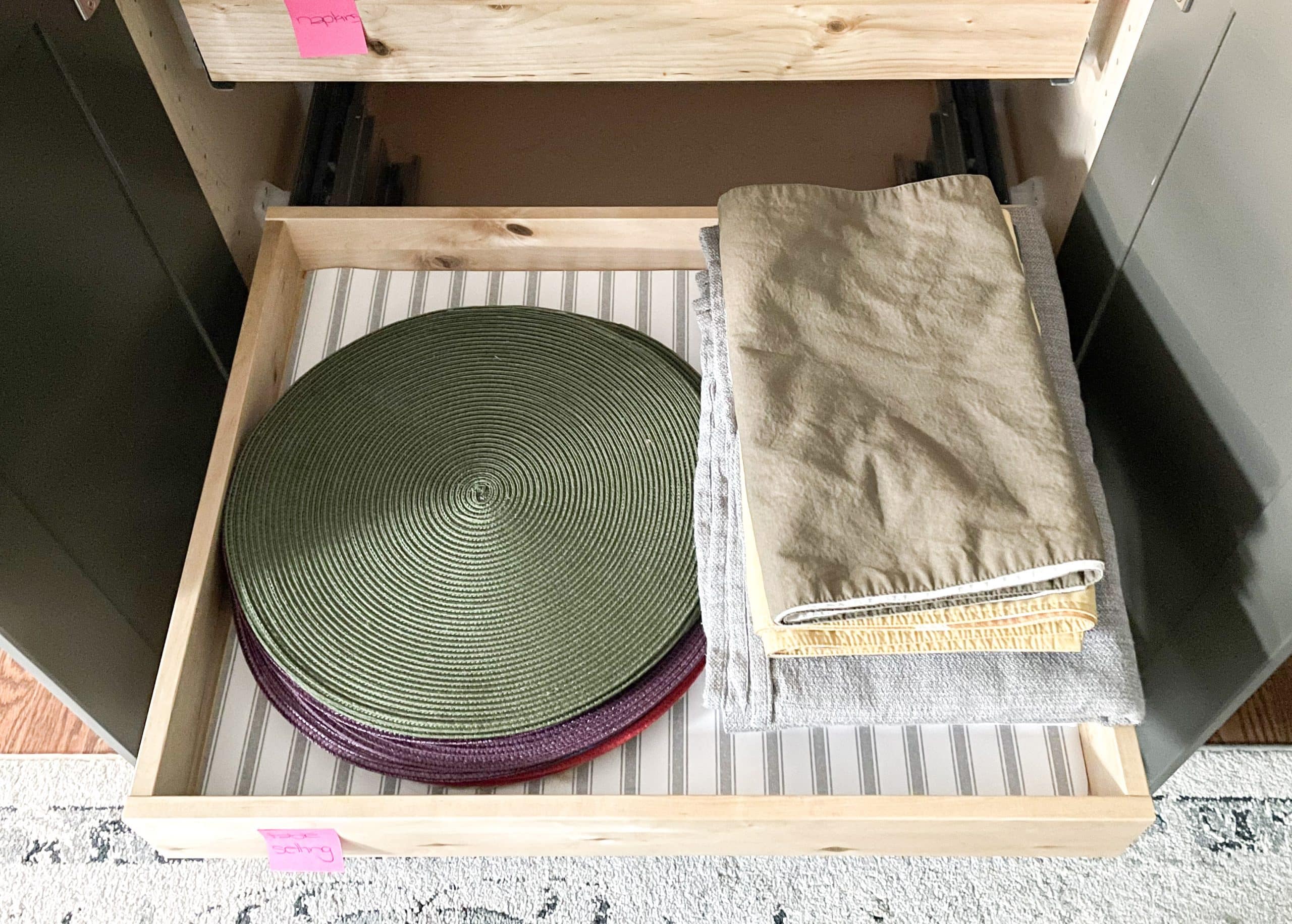 place mats and table coverings in drawer with drawer liner after reorganize your home