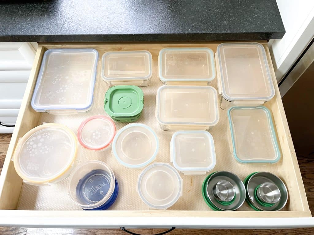 tupperware in drawer with lids on and clear drawer liner