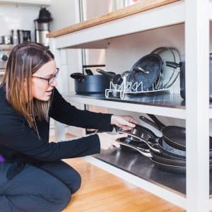organizing pots and pans under a movable kitchen island