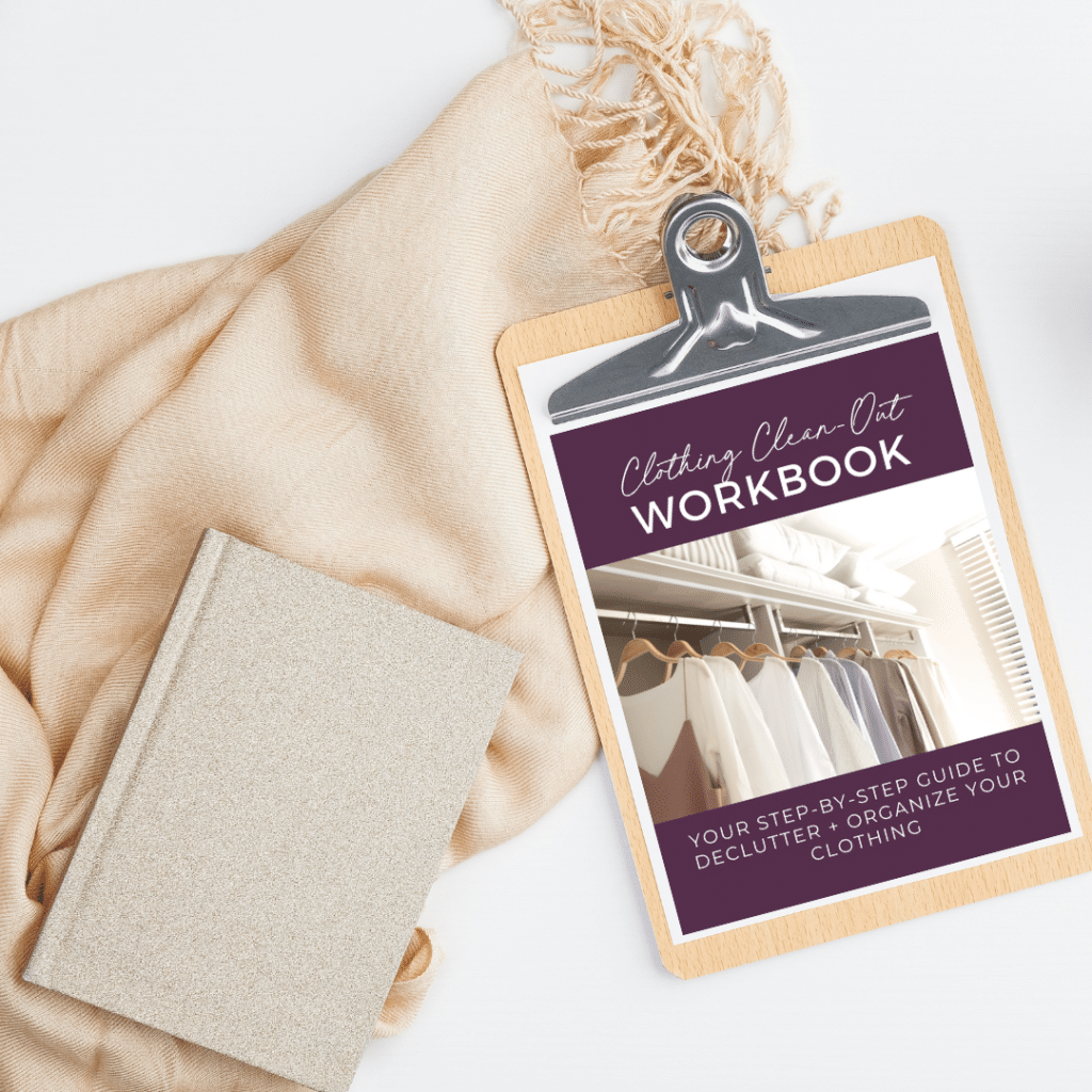 clothing clean-out workbook on clipboard with scarf and notebook