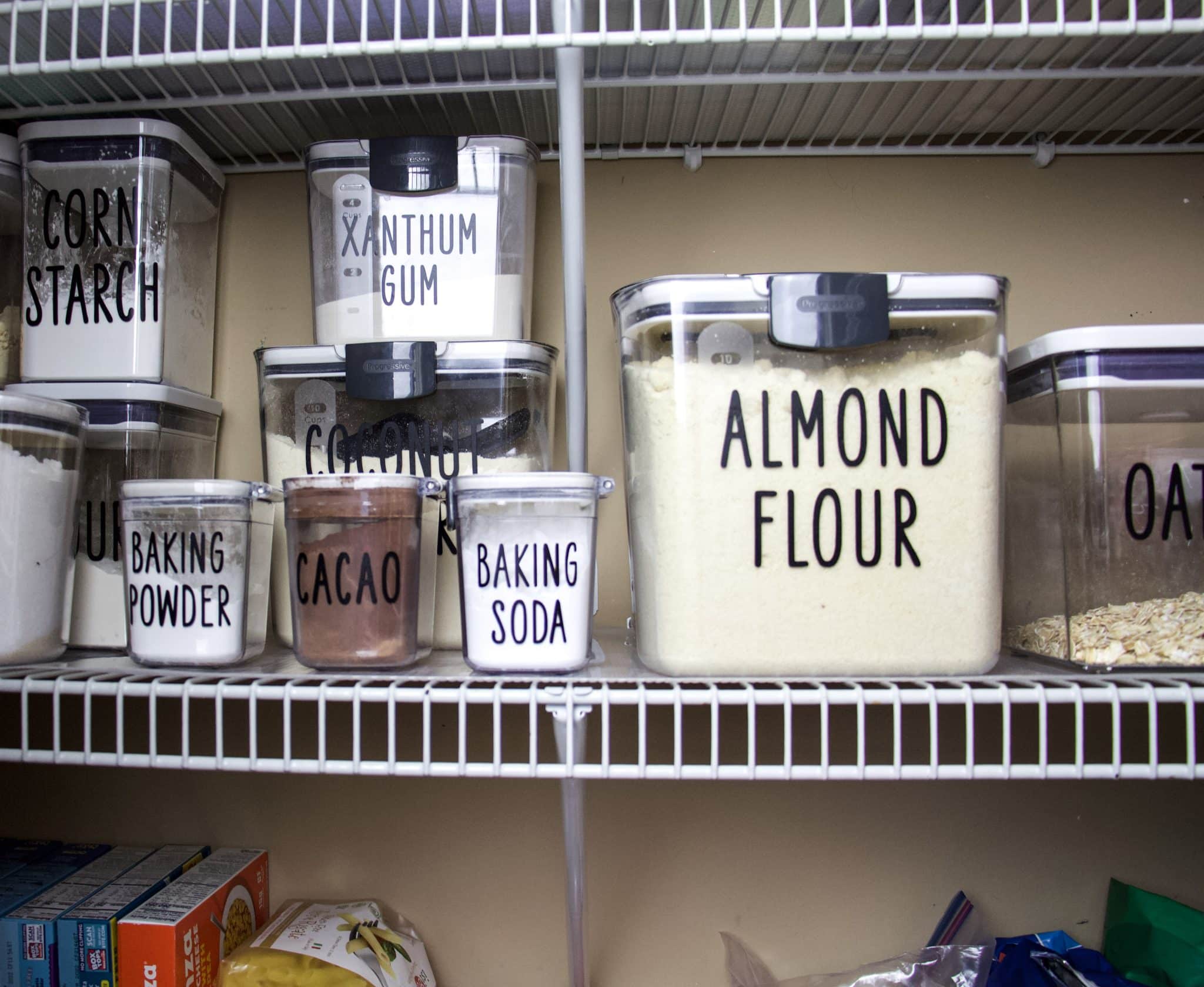 Pantry bins with labels to help with organizing.
