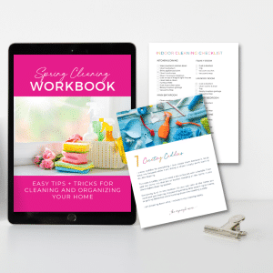 Spring cleaning workbook cover on ipad next to two sheets from workbook and a clip on desk