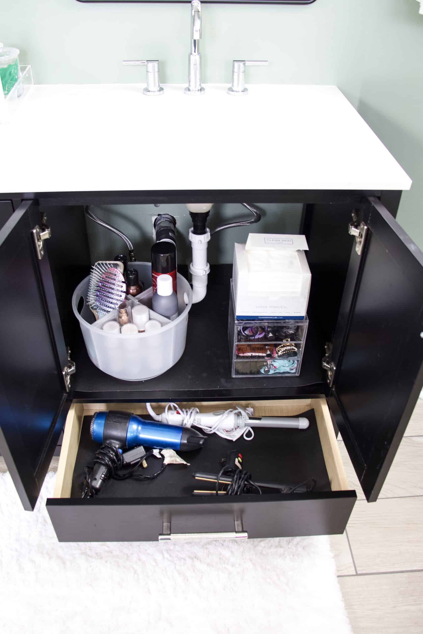under bathroom sink with turntable hair product organizer